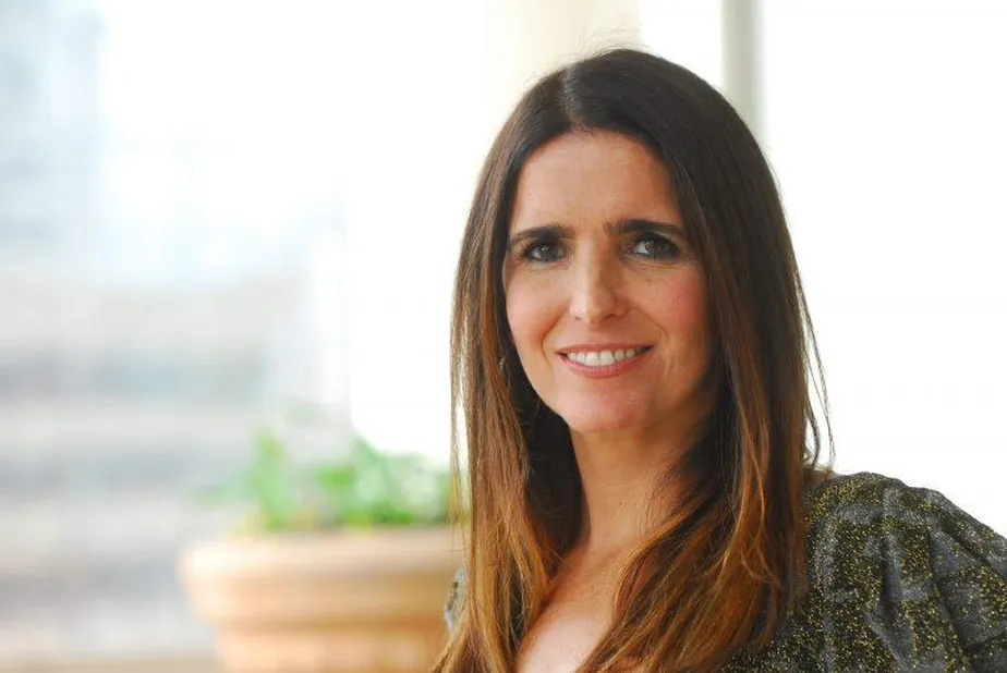 Um retrato em plano m&eacute;dio de Malu Mader em uma livraria de rua no Leblon.