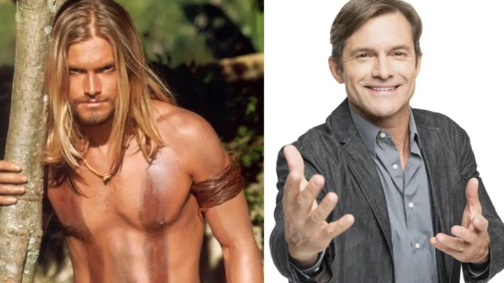 Claudio Heinrich hoje, vestindo um quimono branco de Jiu-jitsu com a faixa preta amarrada na cintura, sorrindo de forma tranquila enquanto segura o filho Karl no colo.