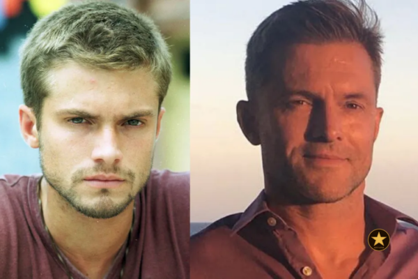 Claudio Heinrich hoje, vestindo um quimono branco de Jiu-jitsu com a faixa preta amarrada na cintura, sorrindo de forma tranquila enquanto segura o filho Karl no colo.